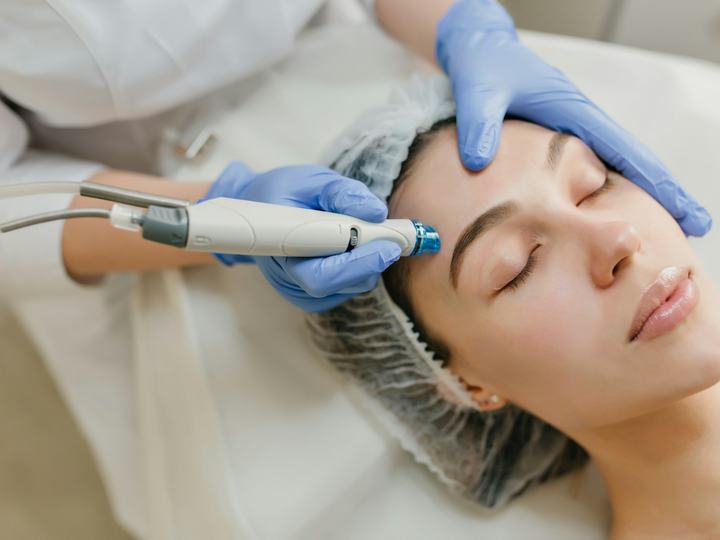 Doctor performing a facial skin treatment