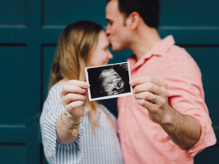 Couple holding an ultrasound photo