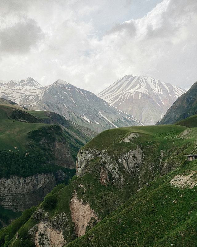 Green valleys and snow-capped peaks of the Caucasus mountains