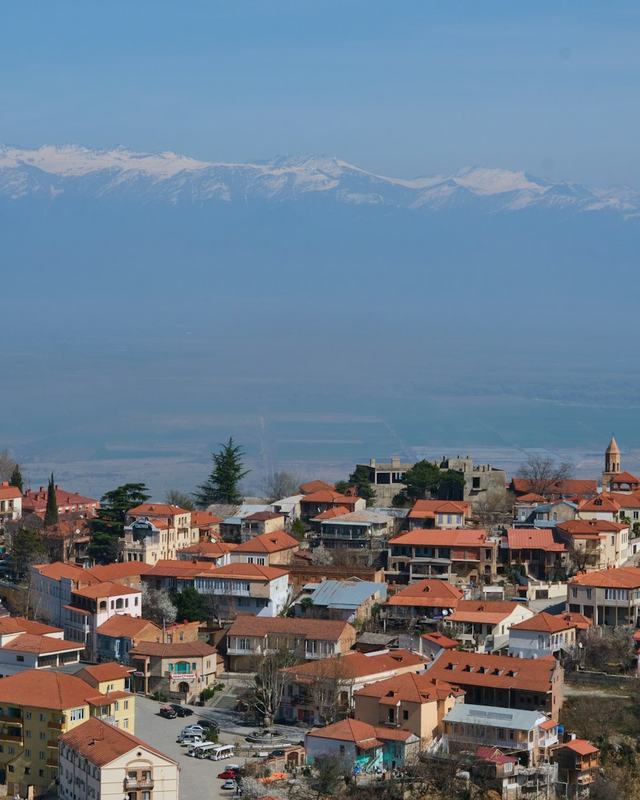 Red roofs of Sighnaghi with the Caucasus mountains behind
